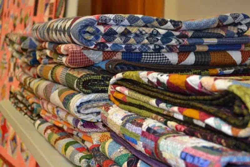Folded Quilts on a Shelf