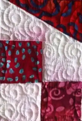 Vibrant patchwork quilt featuring detailed stitching and colorful fabrics, perfect for enhancing your home décor.