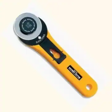 Sharp rotary cutter for fabric and quilting projects. Ergonomic handle for easy cutting. Ideal for quilting and sewing.