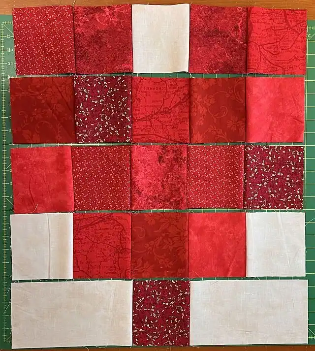 Colorful Christmas quilt blocks with red and white fabric pieces.