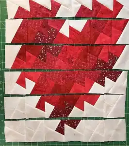 Vibrant red and white Christmas quilt blocks with festive patterns and geometric design for holiday décor.