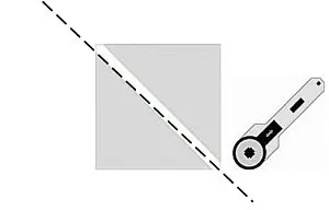 A square with a dashed diagonal line across it and a rotary cutter positioned to cut along the line—an essential step in How to Make Quilt Blocks.