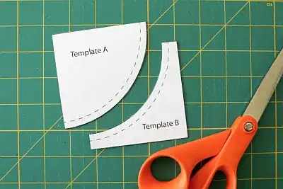 Two paper templates labeled A and B on a green cutting mat, with orange scissors nearby; Template B features a curved cut aligning with Template A.